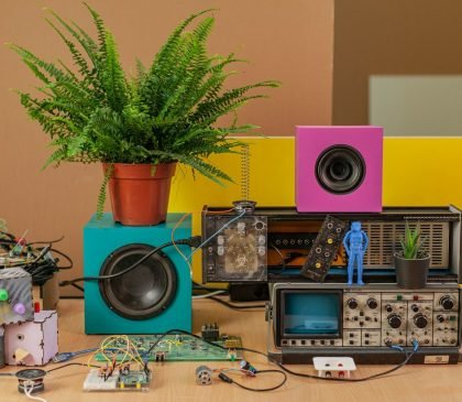 black and silver speaker on brown wooden table