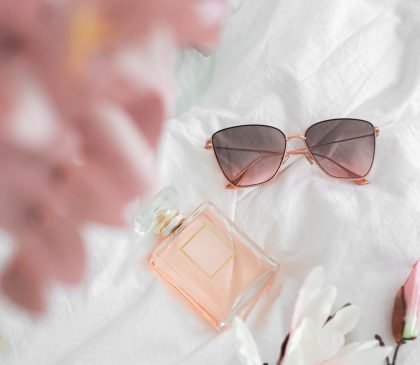 brown framed sunglasses on white and pink textile