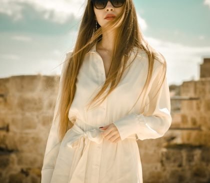 woman in white long sleeve dress wearing black sunglasses